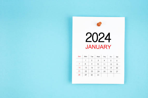 istock January 2024 calendar page with push pin on blue background. 1891487948