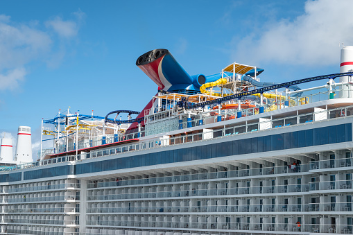 San Juan, Puerto Rico - Nov 22, 2023: Family cruise ship Carnival Celebration with roller coaster and water park docked in port of San Juan, Puerto Rico. Close-up. Side view.