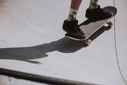 Close-up skateboarder balancing on skateboard at skatepark