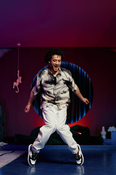 istock Positive Man Dancing Hip-Hop in Studio with Neon Lights 1891569431