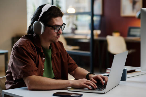 istock Young serious designer in headphones 1891604073