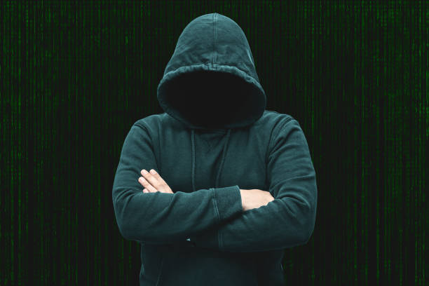 istock Mysterious faceless hooded anonymous computer hacker, silhouette of cybercriminal, terrorist 1891648295