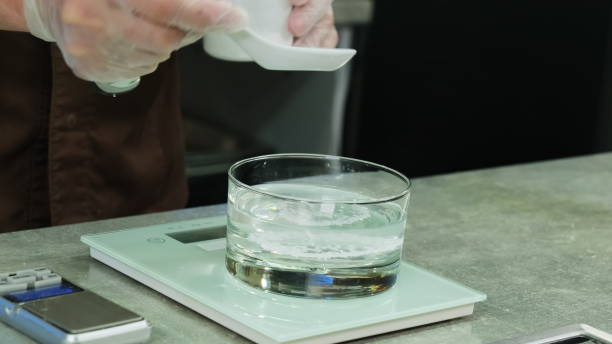 istock Cook sprinkles agar-agar from measuring spoon into glass 1891663326
