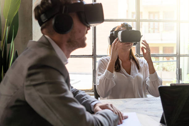 istock Young entrepreneurs having a metaverse remote meeting using 360 VR googles sitting at the office desk - Business people lifestyle concept 1891670824