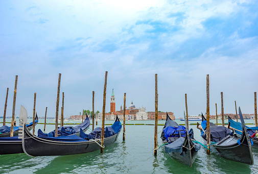 Gondolas near Saint Mark Square (Piazza San Marco) and church of San Giorgio di Maggiore in the background, in Venice, Italy