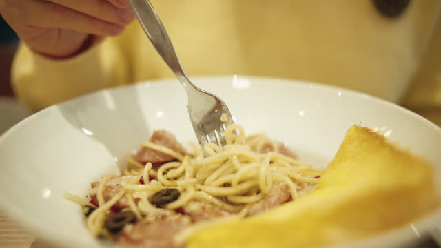 Close up eating pasta at restaurant