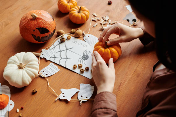 istock Close-up of young unrecognizable woman creating Halloween composition 1891742340