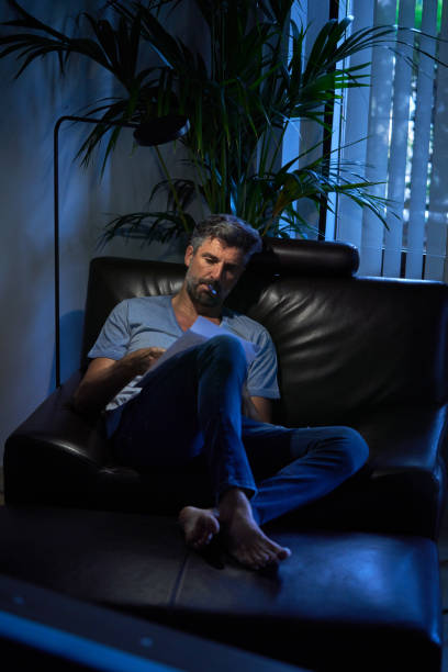 istock Serious businessman working late in dark office room 1891758111