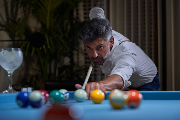 istock Man playing billiards at home 1891760707