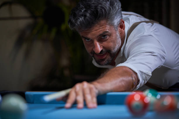 istock Positive man playing billiards at home 1891761730