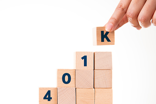 Hand making stair chart with wooden blocks creating word 401K