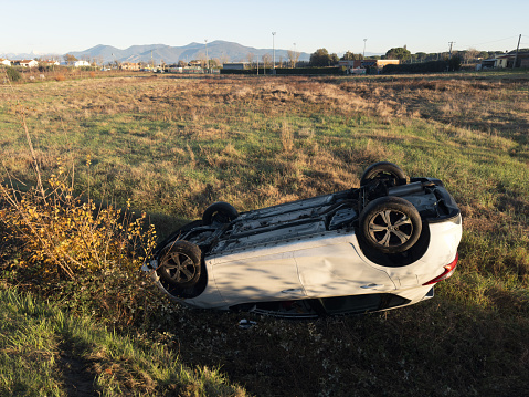 Cenaia, Italy - December 9, 2023: alongside the main road entering the small Tuscan town, a car is upside down, likely after an accident. Cenaia is located in the province of Pisa.