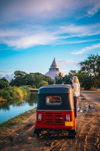 Female tourist taking photos of Sri Lankan landmarks while traveling in a tuk tuk across Sri Lanka.
Tissamaharama.