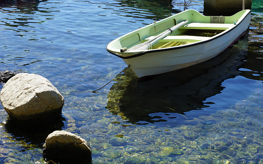 Motor boat floating on clear turquoise water