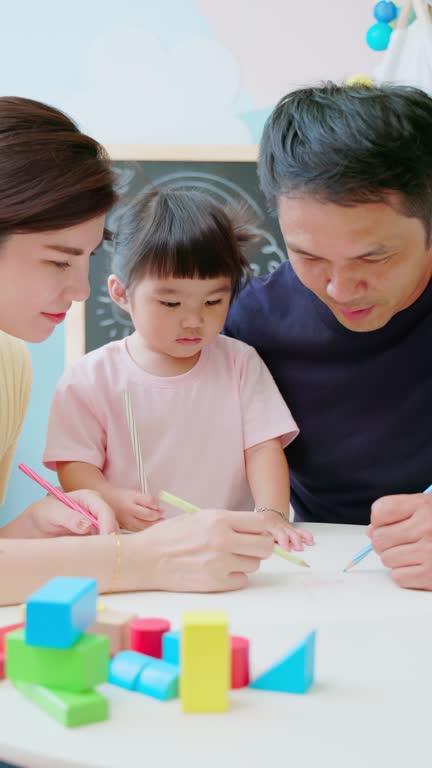 Asian parent painting with kid