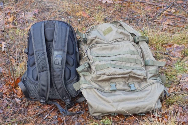 istock two large black and green backpacks lie on the ground 1891903795