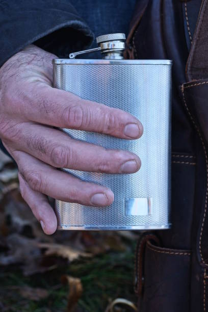 istock hand holds one white metal flask 1891906466