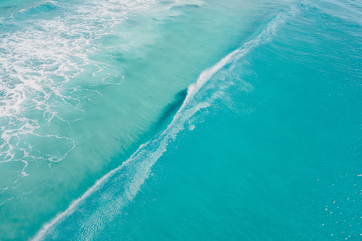 Blue clear ocean and surfing wave. Surfing dream in tropics. Aerial view