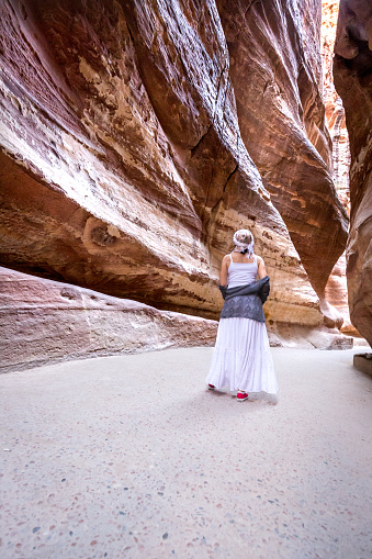 Young female  tourist enjoys walking across the lost city of Petra in Jordan
