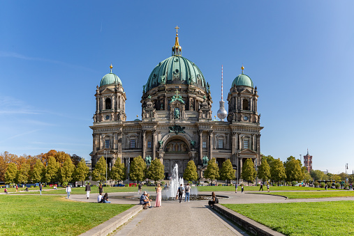 historic statues in in front of cathedral in Berlin under blue december sky