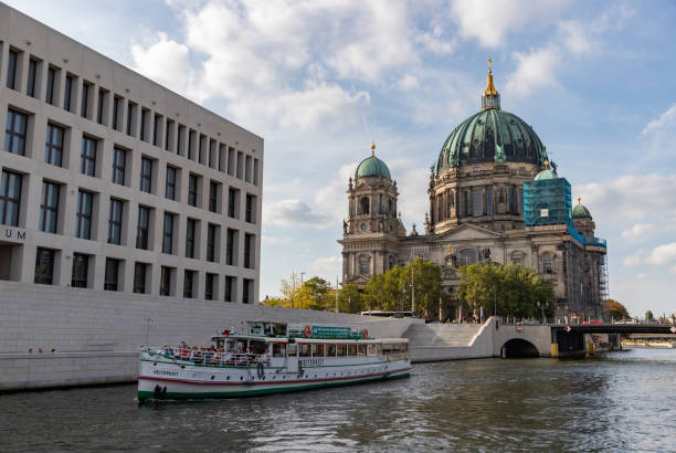 Berlin, Germany - September 26, 2023: A picture of the Berlin Cathedral and a cruise on the Spree river.