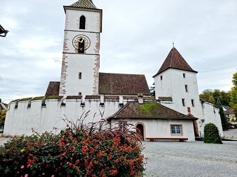 The Fortified Church of St. Arbogast in the municipality of Muttenz in the Swiss canton of Basel-Land is the only church in Switzerland that is surrounded by a defensive wall. The image was capture during autumn season.