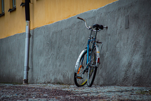 a bicycle leaning against the house wall