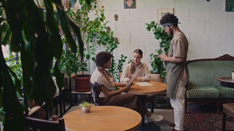 Diverse Girlfriends Ordering Lunch at Cozy Cafe