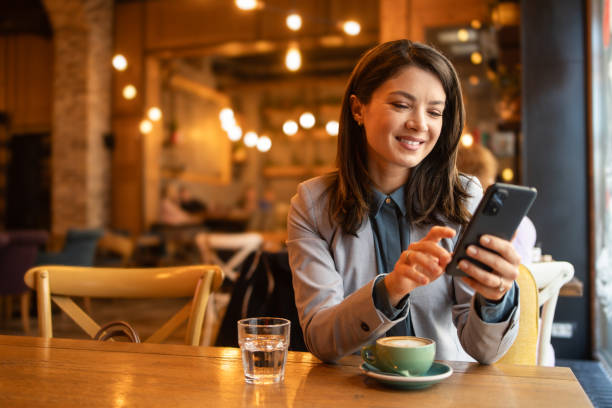 istock Beautiful woman using phone while sitting in cafe, break from work 1892039203