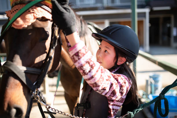 istock Girl preparing for horseback riding 1892051635