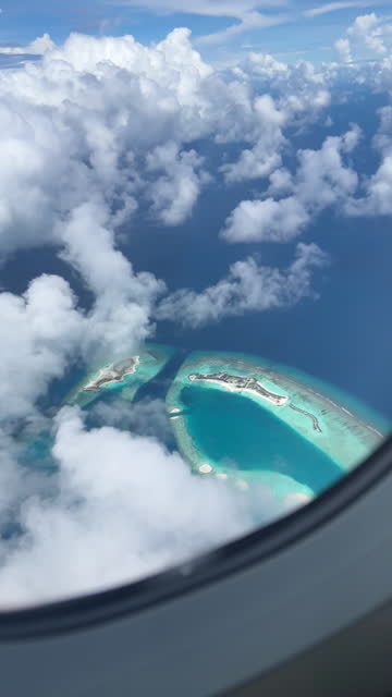 Beautiful island view with cloud sky through airplane window