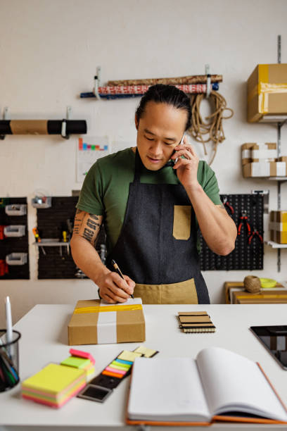 Chinese retail clerk prepares package for shipping