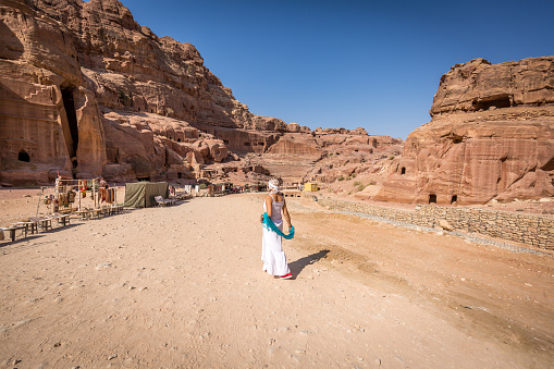 Young female  tourist enjoys walking across the lost city of Petra in Jordan