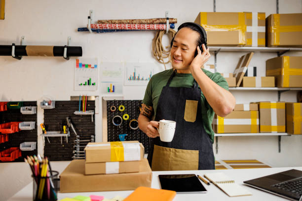 istock Chinese man enjoys music on coffee break in storage room 1892084933