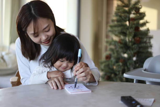 istock Parent and child writing New Year's cards 1892092771