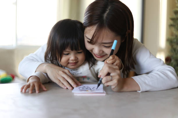 istock Parent and child writing New Year's cards 1892093301