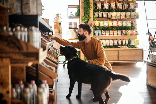 Young Man And His Dog Explore the Pet Store