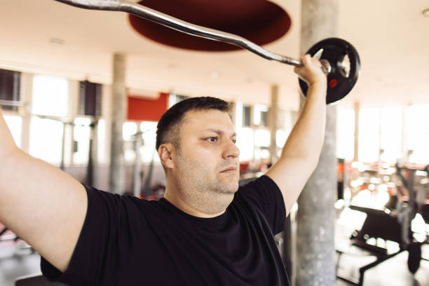 istock Overweight mature man doing weight loss exercise in gym 1892119735