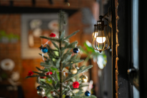 antique electronic lamp red wall lamp tall wall lamp Soft light from the window Blurred Christmas tree background decorated with lights