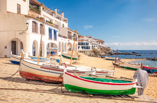 Boats on the Calella de Palafrugell beach, Costa Brava Traditional boats on the sandy beach of the Catalan town of Calella de Palafrugell beach, Costa Brava. gerona province stock pictures, royalty-free photos & images