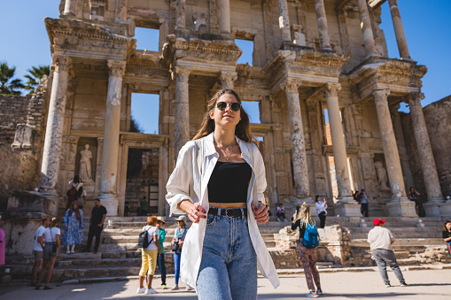 A young female traveler explores the historic Library of Celsus ruins in Ephesus, Turkey, exuding curiosity and wanderlust.