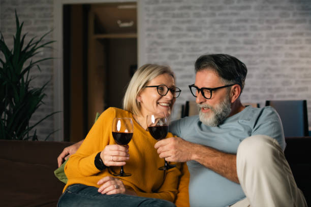 istock a mature couple enjoys wine and watching TV 1892161928