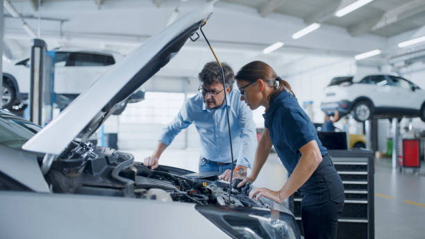 istock Manager And Mechanic Engaging In Detailed Analysis Of Car Engine 1892163520
