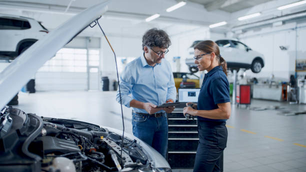 istock Manager And Mechanic Discussing About Car Engine At Auto Repair Shop 1892163531