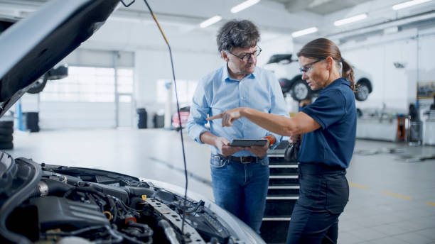istock Manager And Mechanic Deeply Engaged In Examination Of A Car Engine At Workshop 1892163535