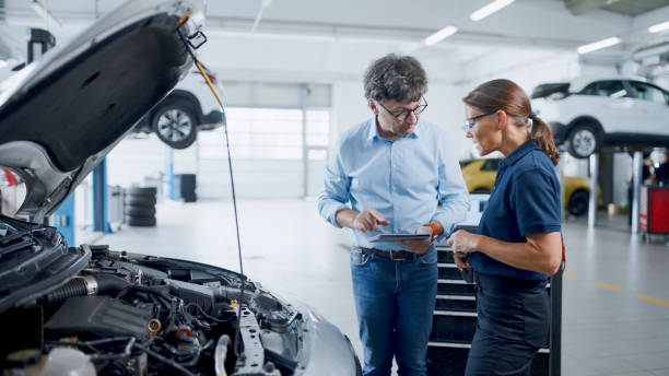 istock Manager And Mechanic Having A Discussion About Car Engine At Auto Repair Shop 1892163537