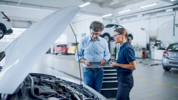 istock Manager And Mechanic Having A Discussion While Examining Car Engine At Auto Repair Shop 1892163540