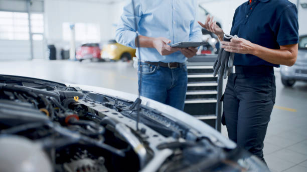 istock Manager And Mechanic Having A Discussion While Examining Car Engine At Auto Repair Shop 1892163542