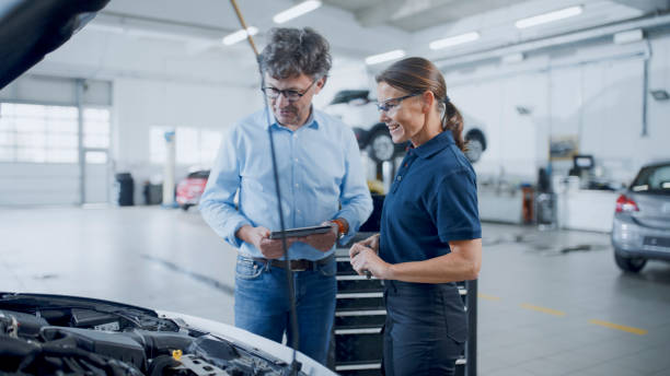 istock Manager And Mechanic Having A Discussion While Examining Car Engine At Auto Repair Shop 1892163543