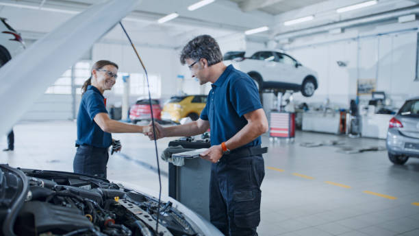 istock Manager And Mechanic Shaking Hands On Successful Examination Of Car Engine 1892173320